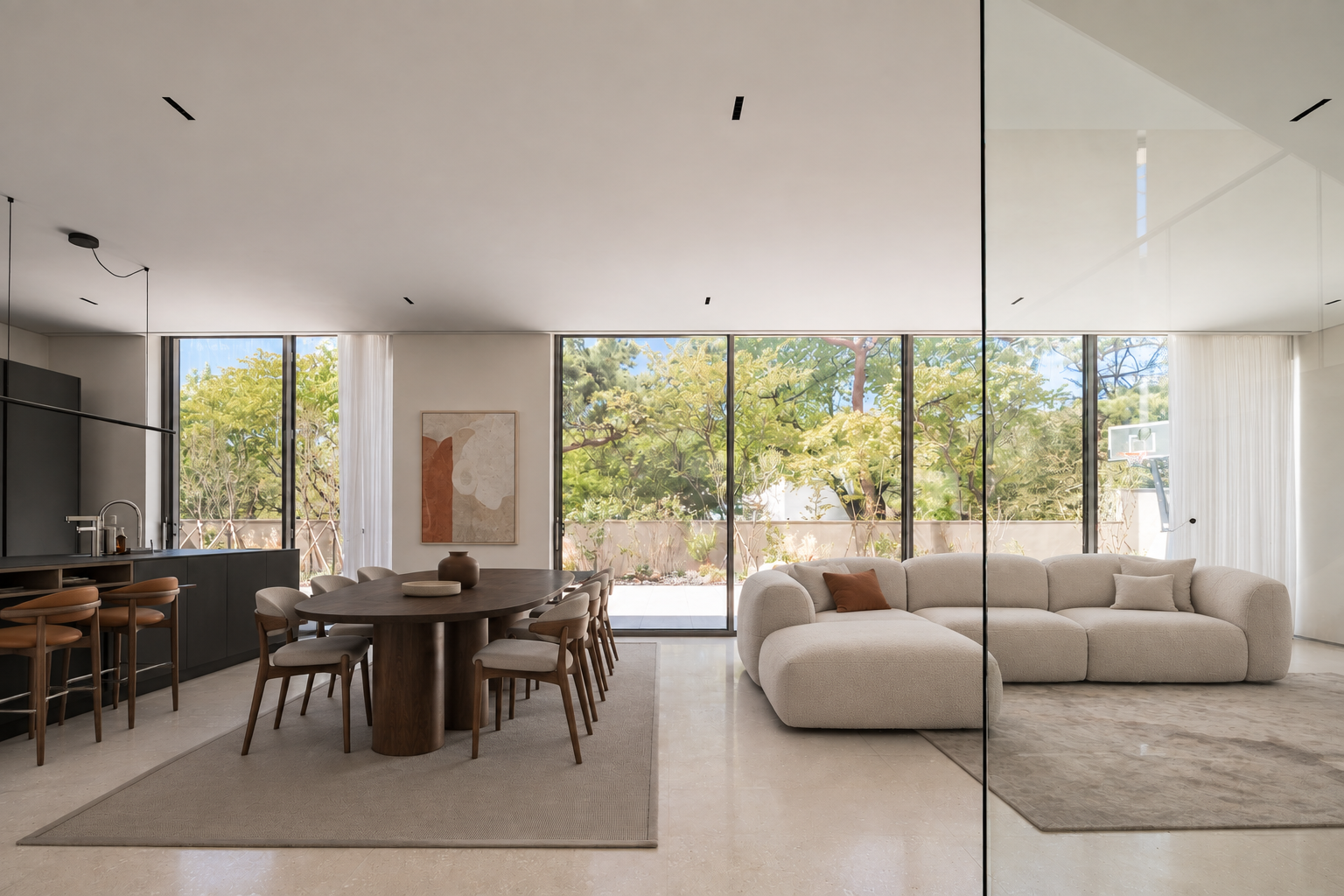 An open-plan interior with full-height windows, dining and kitchen areas, and a living space.